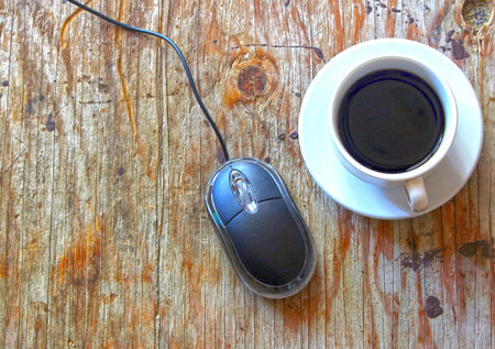 Coffee and mouse on the tableの写真素材