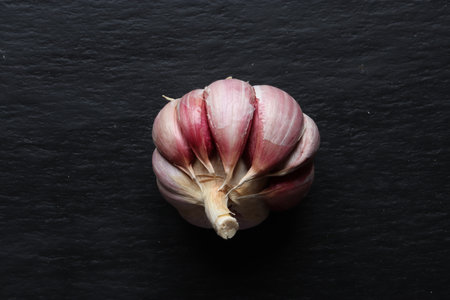 Photography of a peeled garlic head on slate backgroundの写真素材