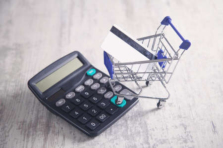 Shopping cart with credit card and calculator.の写真素材