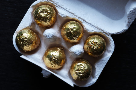 Photography of chocolate easter eggs wrapped in gold foil for food illustrations