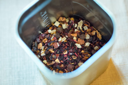 Dried tea leaves in metal bowl. Dried herbs tea leaves close up. Different dry herbs and flowers for making healthy tea background.の写真素材