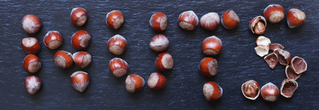 Photography of hazelnuts arranged in shape of word nuts