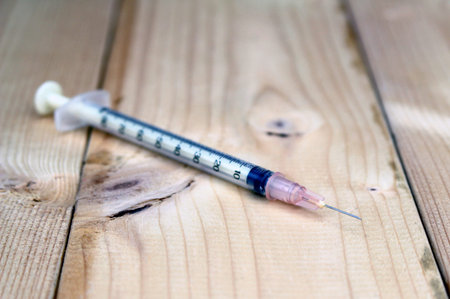 Syringe On Wood Rough Background With Copy Spaceの写真素材