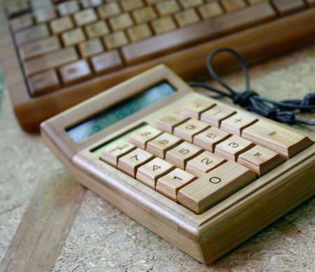 Digital calculator and keyboard bamboo on woodの写真素材