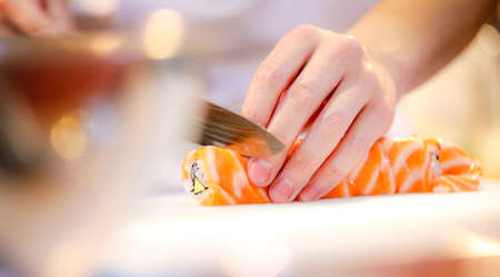 chef hands preparing japanese food, chef making sushi, Preparing Maki Sushi rollの写真素材