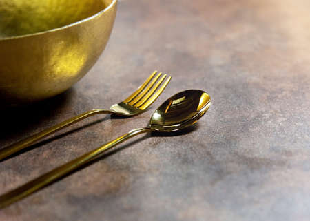Silver spoon and silver fork at restaurant tableの写真素材