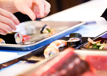 chef hands preparing japanese food, chef making sushi, Preparing Maki Sushi rollの写真素材
