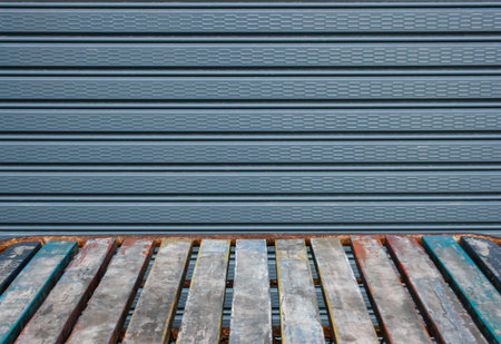 Old wooden table in front of the steel shutter door