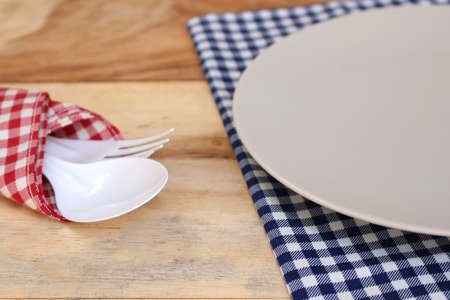 the plate on checkered tableclothの写真素材