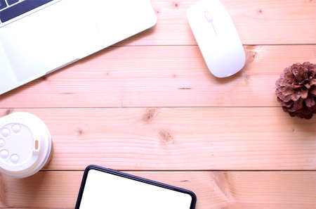 top view flat lay office table desk. workspace with notebook ,smartphone, cup coffee and mouse on copy spaceの写真素材
