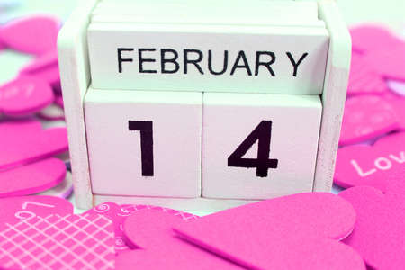 wooden calendar show of February 14 with red and white heart for valentine day backgroundの写真素材