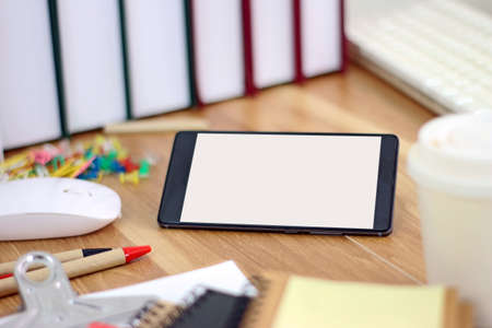 Workspace with smartphone and office equipments on wood desk work backgroundの写真素材