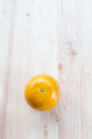 Orange on wooden planks.の写真素材