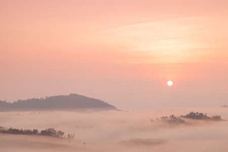 Fog covered mountains And the Rising Sunの写真素材
