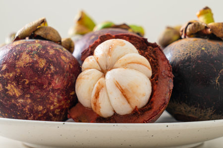 fresh mangosteen on white plate