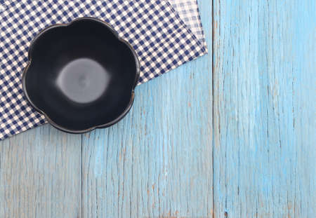 black plate on tablecloth on wood table backgroundの写真素材
