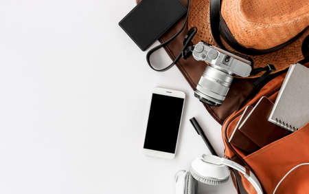 Top view of essential modern. travel accessories on white wooden table background. over lightの写真素材