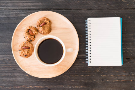 black coffee and cookies with laptop and note bookの写真素材