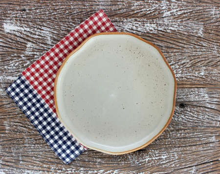 Empty modern ceramic plate on wood table background ,top viewの写真素材