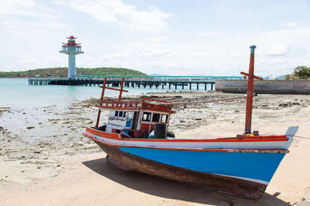 Wooden fishing boat moored on the beach.の写真素材