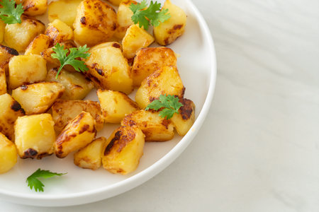 Roasted or grilled potatoes on plate