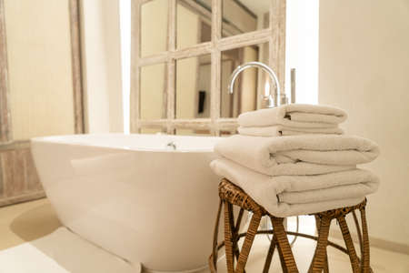 towel with bath tub in bathroomの写真素材