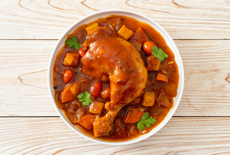 chicken stew with tomatoes, onions, carrot and potatoesの写真素材