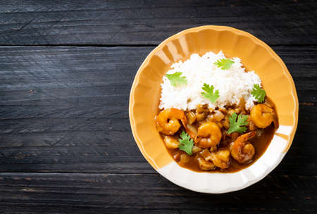 Shrimps in curry sauce on riceの写真素材