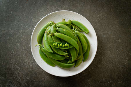 fresh sweet green peas on plateの写真素材