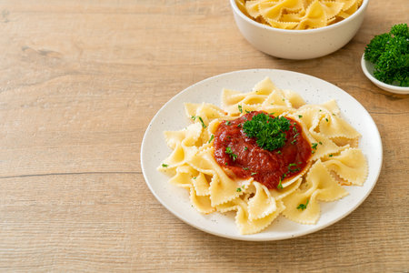 farfalle pasta in tomato sauce with parsleyの写真素材