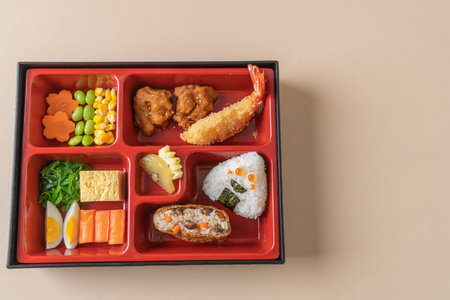 (inari sushi) sushi rice wrapped in dried tofu with fried shrimp and fried chicken in bento setの写真素材