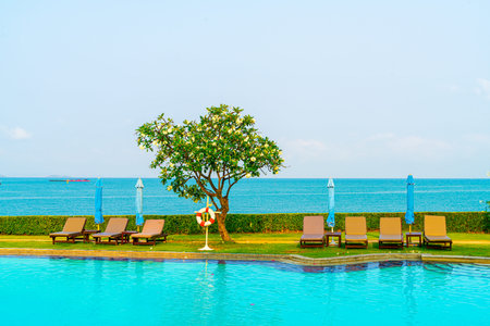 chair pool around swimming pool with sea background