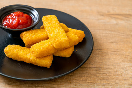 crispy fried fish fingers with breadcrumbs served on plate