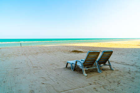 beach chair on sand with ocean sea backgroundの写真素材