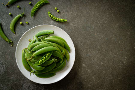 fresh sweet green peas on plateの写真素材