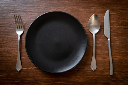 empty plate or dish with knife, fork and spoon