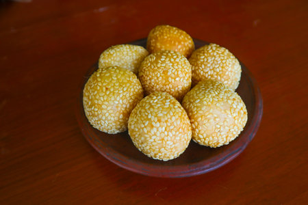 onde-onde or sesame ball or Jian Dui is fried Chinese pastry made from glutinous rice flour and coated with sesame seeds filled with bean paste. isolated on white backgroundの素材