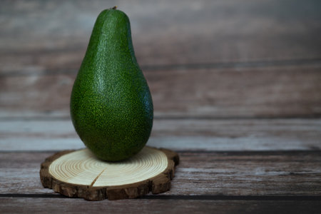 organic avocado from sustainable agriculture from andalucia, spain on a wooden boardの素材