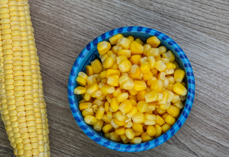 Canned sweet corn in the bowl on wood backgroundの素材