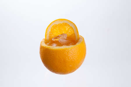 orange juice in orange peel  in isolate white backgroundの写真素材