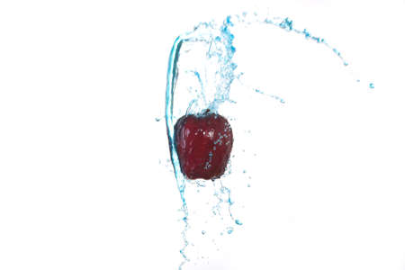 Red Apple With blue water splash in isolate white backgroundの写真素材