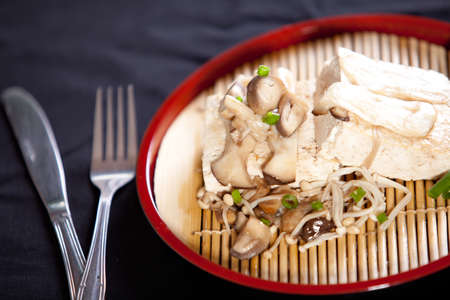 tofu steak with mushroom and soy sauce on black backgroundの写真素材
