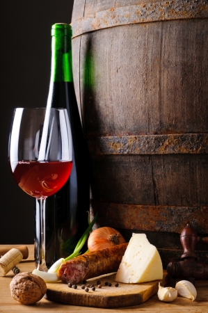 Stille life with traditional food, red wine and wooden barrelの写真素材
