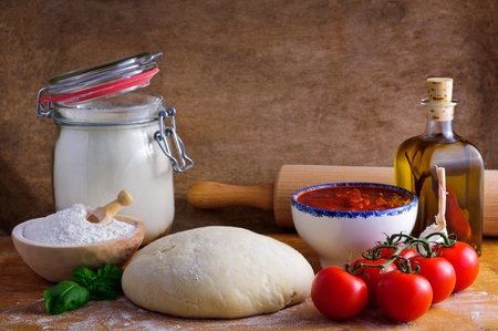 Traditional pizza dough and ingredientsの写真素材