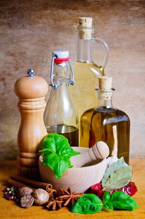 Still life with bottles of olive oil, herbs and spicesの写真素材