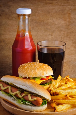 Fast food with burger, hot dog, french fries, tomato ketchup and colaの写真素材