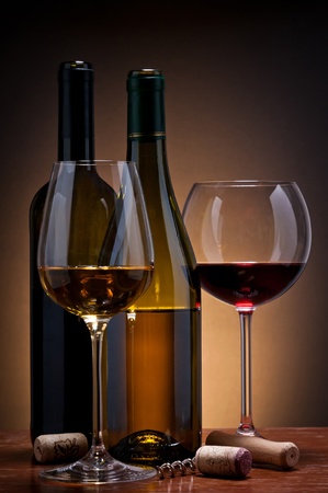 still life with glass and bottles of red and white wineの写真素材