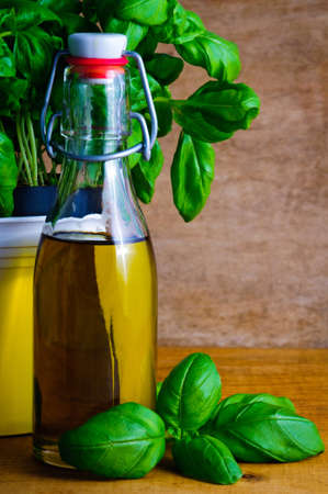 Bottle of olive oil and fresh green basilの写真素材