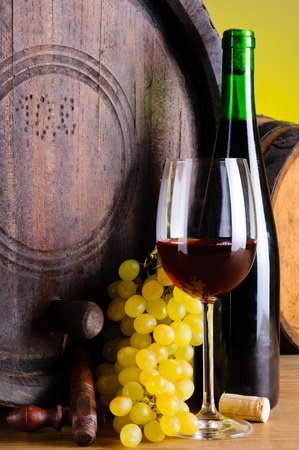 still life with red wine, grapes and wooden barrelの写真素材