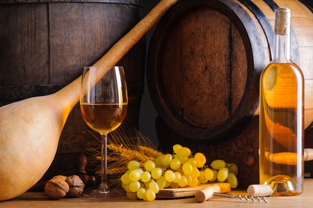 Still life with traditional cellar, white wine, grapes and wooden barrelsの写真素材